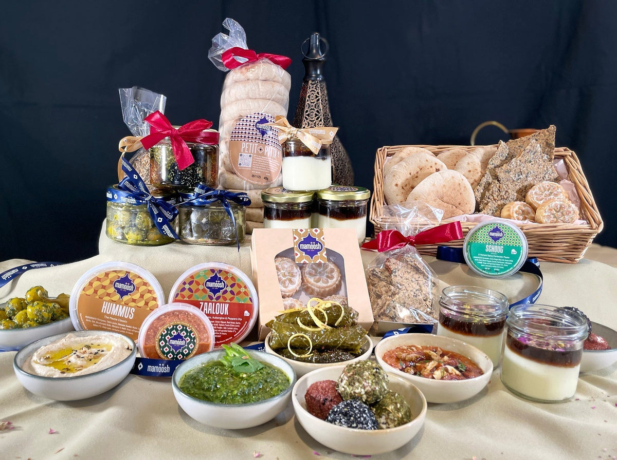 An array of open dishes from Mamoosh fresh festive hamper including dips, pittas and festive treats  